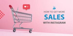 A shopping cart with a red Instagram-like heart notification above it sits on a pink background. Beside it, text reads "Discover how to get more sales with Instagram.