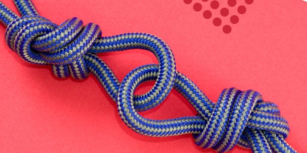 A blue and yellow braided rope tied in a decorative knot against a bright pink background, with small red dots clustered in the upper right corner—perfect for sharing on Pinterest to connect with creative audiences.