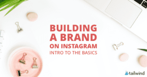 Flat lay of office supplies, a white keyboard, and plants with text: "Building a Brand on Instagram—Intro to the Basics." Perfect for learning how building a brand on Instagram starts. Tailwind logo in the bottom right corner.