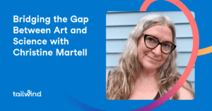 A smiling woman with long, wavy gray hair and glasses stands in front of a blue wall. Text reads, "Bridging the Gap Between Art and Science with Christine Martell." Discover how Pinterest scheduling can enhance creativity. Tailwind logo appears in the bottom left.