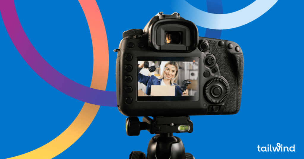 Photo of the screen on the back of a DSLR camera with the image of a smiling woman holding up headphones and a videogame controller. On a blue background with the word Tailwind in white font.