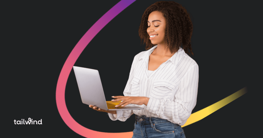 Picture of a woman holding an open laptop and smiling down at the keyboard while she types something. On a black background with the word Tailwind in white letters.