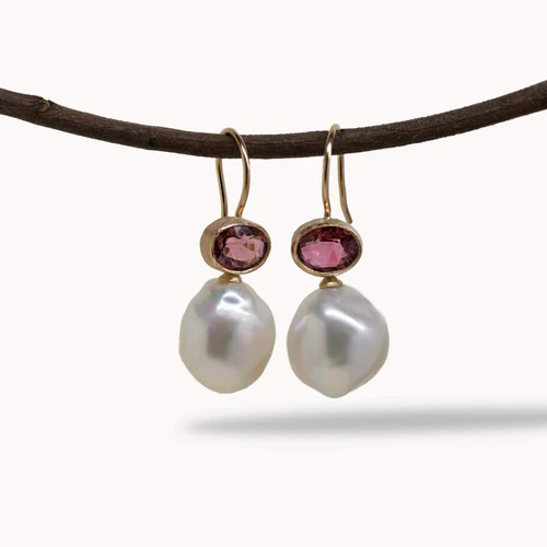 Photo of two pearl and pink stone drop earrings.