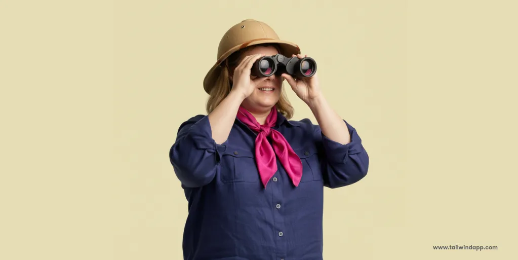 A woman in a safari hat using binoculars against a beige background, symbolizing Pinterest search exploration.