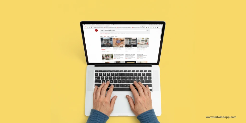 Blog header image of hands typing on a laptop with Pinterest search open and 'no results found' displayed, symbolizing troubleshooting Pinterest search issues.