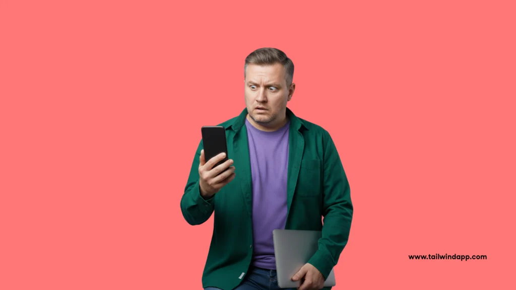 Man holding a phone and looking surprised against a coral background, representing what happens if I stop posting on Pinterest and engagement effects.