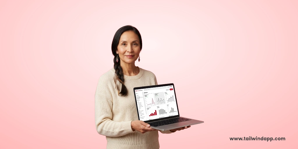 Woman holding a laptop with analytics on screen, pink background.