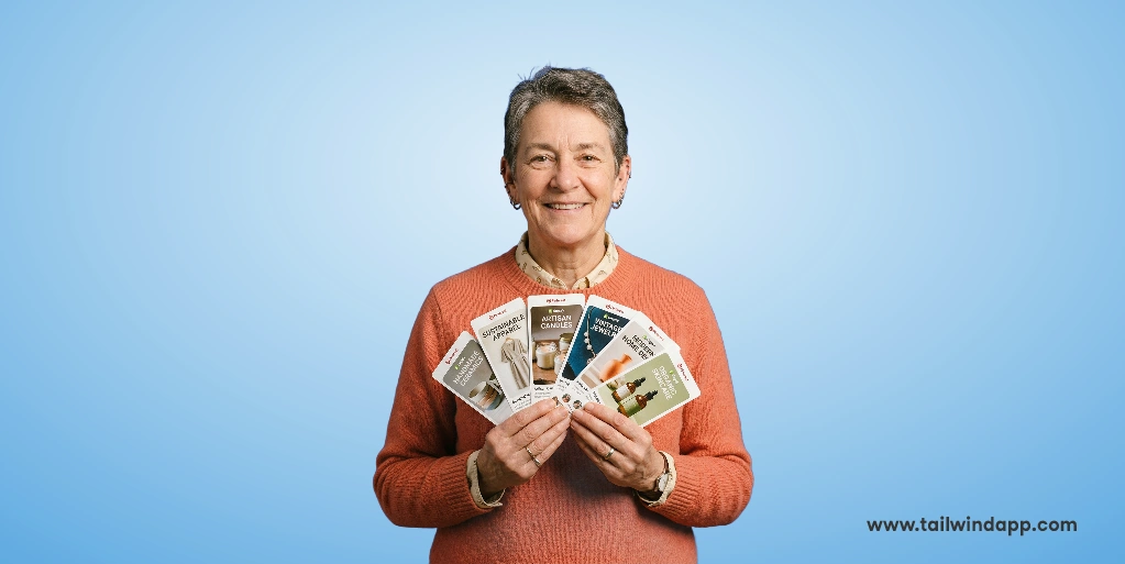 Person holding Pinterest cards against a blue background, related to Shopify sales strategies.